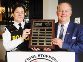 The Haldimand-Norfolk Community Street Crime Unit received a Law Enforcement Recognition Award Thursday at the annual Crime Stoppers luncheon in Renton. The street crime unit has arrested 110 people in the local area over the past year in connection with offences ranging from narcotics to property crime. At left is Insp. Lisa Anderson, interim chief of the Norfolk OPP, while at right is David Forster of Bolton, president of the Canadian Crime Stoppers Association and a guest speaker at Thursday’s luncheon.     MONTE SONNENBERG / SIMCOE REFORMER