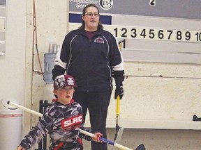 Parent/coach Jana Bartsch watches as a young curler delivers a stone during Milo Community School’s annual Fun Spiel. Photo courtesy Palliser Regional Schools