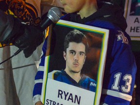 Young hockey players held up signs with the names of each  person on the Humboldt bus. Attendees slapped their hockey sticks on the ground as each name was read over a microphone.