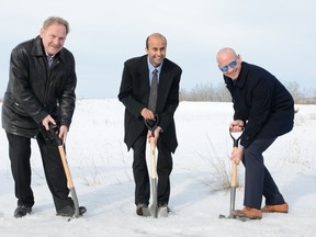 (From left to right) Hank Brzezinski, Harish Consul, and Jeff Genung dig their spades into the snow, symbolizing the start of construction for River Heights Place.