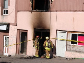 Kenora Fire and Emergency Services Chief Todd Skene and Captain Larry Cottam wearing self contained breathing apparatus investigate the cause of a fire that destroyed one apartment and damaged several others at the Matheson St. block early Friday morning, Apr. 20.
Reg Clayton/Daily Miner and News