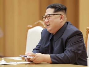 This April 14, 2018 picture released from North Korea's official Korean Central News Agency (KCNA) on April 16, 2018 shows North Korean leader Kim Jong-Un speaking with Song Tao, head of the International Liaison Department of the Central Committee of the Communist Party of China, who led the Chinese art troupe in Pyongyang. / AFP PHOTO / KCNA VIA KNS AND AFP PHOTO