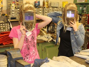 Kincardine District Secondary School reached out to female students and local women interested in finding out the options of a trades-based education and trades-based career choices during the Women's Tech Promo Event at the KDSS on April 11, 2018. Pictured: Autumn Blake and Elia Schausbreitner try on some of the safety equipment required when doing a welding job during the KDSS Female Student Night Out Event on April 11, 2018. (Ryan Berry/ Kincardine News and Lucknow Sentinel)