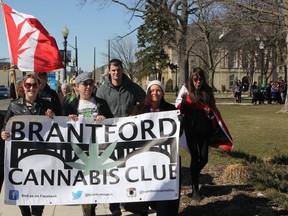 Members of the Brantford Cannabis Club lead the way during a march through part of the downtown on Friday to commemorate 4/20, a rally held annually in support of the legalization of marijuana. (Vincent Ball/The Expositor)