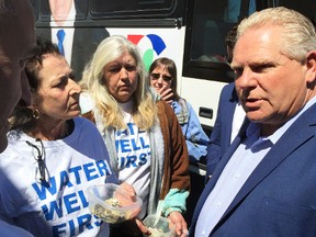 Ontario Progressive Conservative leader Doug Ford is greeted by a number of Water Wells First members during a visit to the Wallaceburg Country Style coffee shop on Friday, April 20. They wanted answers from Ford about their claims that local water wells have gone bad due to wind turbine construction.