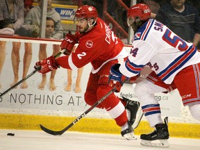 Soo Greyhounds Noah Carroll is chased by Kitchener Rangers Givani Smith during the first period of Western Conference championship series at Essar Centre in Sault Ste. Marie, Ont., on Friday, April 20, 2018. (BRIAN KELLY/THE SAULT STAR/POSTMEDIA NETWORK)