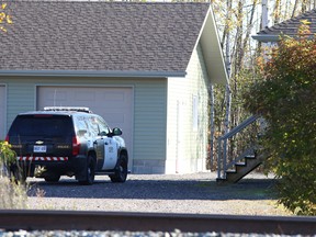 OPP investigate at the home of Sheri-Lynn McEwan in Estaire in 2013. McEwan, 40, was found gravely wounded inside the residence on Oct. 7. She subsequently died of her injuries. (John Lappa/Sudbury Star file photo)