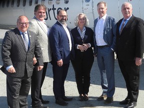 Greater Sudbury Major Brian Bigger, left, Todd Tripp, Greater Sudbury Airport CEO, second from left, Sudbury Liberal MPP and Energy Minister Glenn Thibeauolt, third from left, Lise Poratto- Mason, chairwoman of the Sudbury Airport Community Development Corporation, third from right, Vince Pollesel, vice-chairman of the SACDC, second from right, and Paul Moreira, Porter Airlines' senior vice-president and chief operating officer, stand in front of Porter Airlines plane set to take off Friday at the Greater Sudbury Airport. (Harold Carmichael/Sudbury Star)