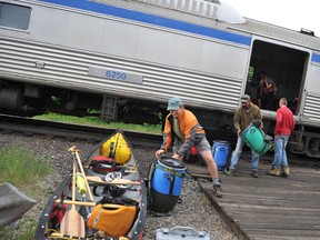 Canoeists unload gear from the Budd car at the Via Rail train in Biscotasing, north of Sudbury. (Postmedia file photo)