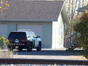OPP investigate at the home of Sheri-Lynn McEwan in Estaire in 2013. McEwan, 40, was found gravely wounded inside the residence on Oct. 7. She subsequently died of her injuries. (John Lappa/Postmedia File Photo)