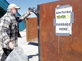 Bob Robb unloads a bag of garbage at the Quinte Exhibition grounds after collecting trash and recyclable items Saturday in east-end Belleville. Hundreds of volunteers took part in the cleanup in several municipalities, following work earlier in the week by about 1,200 students.