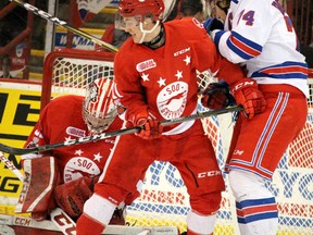 Soo Greyhounds Mac Hollowell defends against Kitchener Rangers Connor Bunnaman in front of goalie Matthew Villalta during the first period of the second game of the Western Conference Championship Series against Kitchener Rangers at Essar Centre on Saturday.