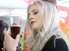 BRIAN KELLY/Sault Star
Sleeping Giant Brewing Company representative Jenna Graham serves a sample of one of three products from the Thunder Bay business featured at the seventh annual Sault Ste. Marie Beer Festival. Bay Street Brown, 360 Pale Ale and Mr. Canoehead were available to try. Canadian Bushplane Heritage Centre hosted the event on Saturday.