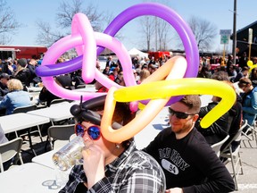 Trenton's Victoria Vajda drinks inconspicuously with her husband, Steve, at the Hops on the Water Craft Beer Festival Saturday at the Front Street Farmers' Market in Trenton. Back for its second year, the event drew a large crowd.