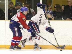 Taylor Woolcott of the Rayside-Balfour Canadians battles for the puck with an unidentified Cochrane Crunch player during NOJHL championship series action in Sudbury, Ont. on Sunday April 22, 2018. Gino Donato/Sudbury Star/Postmedia Network