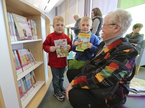 Aiden and Brody Johnson and their grandmother, Mary Johnson, explore the collection at the new Rideau Heights branch of the Kingston Frontenac Public Library.