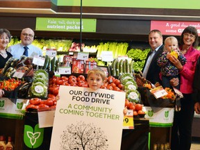 Stratford’s second annual City-wide Food Drive is set for May 6-12. Pictured from left are House of Blessing executive director Theresa McMurray, Tom Patterson from the St. James Food Bank, Sherry LeSouder from the St. Paul’s Church Food Bank, Stratford Sobeys manager Jim MacGregor, Emerson Sealey (holding the sign), Mayor Dan Mathieson, Ruth Sealey from the Avondale United Church Food Shelf (holding Abbey Sealey), Dave O’Reilly from the St. Vincent de Paul Food Bank, and Barry Clarke from The Salvation Army Stratford and Area. (Galen Simmons/The Beacon Herald)