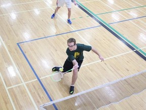 Nolan Kadachuk put the birdie over the net in boys’ doubles play at NESSAC Pod Playoffs for Badminton at MUCC on Wednesday, April 18.