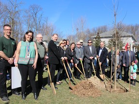 School officials, parents, dignitaries and students participate in a tree planting on Monday to celebrate a green project that will transform the property at St. Gabriel Catholic Elementary School. (Michelle Ruby/The Expositor)