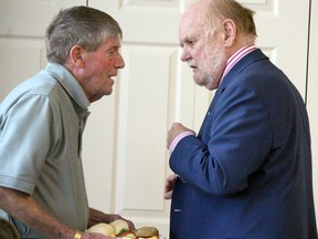 Bob Wilding (left) speaks with Sault College president Ron Common before a board of governors meeting in October 2017.