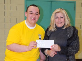 St. Benedict student council president Alex Cimino presents Kim Hancock with a cheque for Mothers Against Drunk Driving (MADD) Canada on April 23. Supplied photo