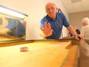 One of the many participants of the Melfort Senior’s Fun Day sends a slider down the shuffleboard table on April 19.