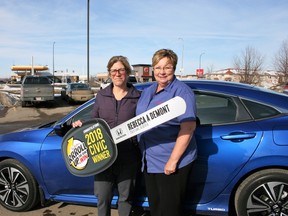 Cold Lake’s Rebecca DeMont (left) won a brand-new Honda Civic by rolling up the rim of her Tim Hortons coffee cup. Local franchise owner Connie Grant presented her with the keys to the car last month.