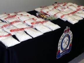 Roughly $385,000 worth of illegal drugs and nearly $50,000 in cash was seized by Timmins Police and Ontario Provincial Police as the result of several search warrants executed in Timmins last week. Three local persons are facing trafficking charges.  LEN GILLIS / Postmedia Network