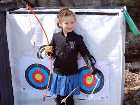 Claire Henshell, 5, of Richards Landing, takes part in her first archery lesson. DAN KERR/SPECIAL TO THE STAR