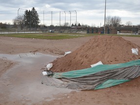 A pile of fill surrounded by puddles sits on the infield at Tom Williams Park on Tuesday. (Rob Gowan The Sun Times)