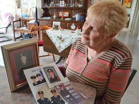 Hazel Hahn looks at a mid-1950s portrait of her father, Arthur Lemcke, the first of four generations of Lemckes to enter policing. Three generations of Lemckes are show here. Below him are, left to right, his sons Albert, Roy and Carman, and below them are, left to right, great-grandson Bryan, grandson Bruce, and grandson Bill. Photo taken on Tuesday at Hahn's Springmount-area home.(Scott Dunn/The Sun Times)