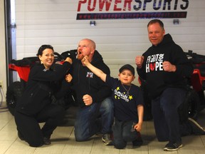 (Left to right) Robyn Cartwright, Scott Cartwright, Jordan Cartwright and Raphael Bergmann. Jordan received a Honda Quad as an early birthday gift, due to his selfless gift-giving idea for terminally ill or critical care children.