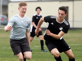 McGregor Panthers' Lorenzo Bortolotti, right, chases North Lambton Eagles' Ian Straatman during the second half of an LKSSAA senior boys' soccer game at John McGregor Secondary School in Chatham, Ont., on Tuesday, April 24, 2018. Abdo Al Najjar of the Panthers scored early in the first half, but Shawn Kwarciak of the Eagles scored twice in the second half for a 2-1 win. (MARK MALONE/Chatham Daily News/Postmedia Network)