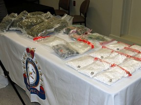 Roughly $385,000 worth of illegal drugs and nearly $50,000 in cash were seized by Timmins Police and Ontario Provincial Police as the result of several search warrants executed in Timmins last week. Three local persons are facing trafficking charges. LEN GILLIS / Postmedia Network