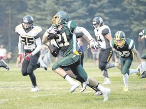 Canmore Wolverines' George Reed runs with the ball against the Drumheller Titans during a high school football game at Millennium Park in Canmore on Sept. 2, 2017. Pam Doyle/ pamdoylephoto.com