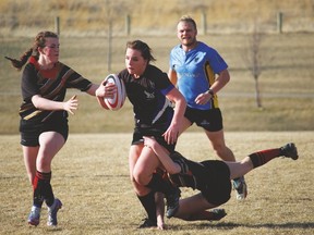 Hawk Makena Wright runs with the ball while a Chinook High School player attempts a tackle during a game last Thursday in Lethbridge. Stephen Tipper Vulcan Advocate