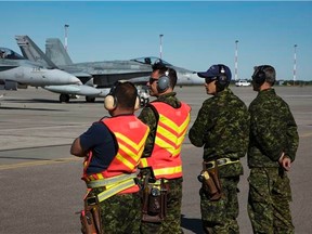 CF-18 Hornets and ground crew prepare to launch as part of the morning wave of Exercise Maple Flag 50 at 4 Wing Cold Lake last May.
