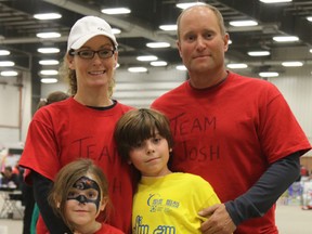 Cancer survivor Josh Bauman poses with his family, mom Bobbi Chamberlain, dad Michael Bauman  and sister Janee Bauman at the Relay for Life in 2015 at Evergreen Park.