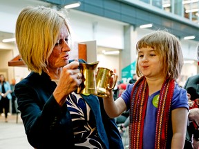 Premier Rachel Notley (left) shares a toast with Morgan Stevens, 3, at Norquest College in Edmonton on Wednesday April 25, 2018. Larry Wong/Postmedia Network