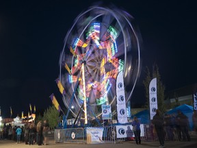 Ferris Wheel riders spin into the night at the Sustainival carnival in Fort McMurray Alta. on Saturday September 5, 2015. Garrett Barry/Fort McMurray Today/Postmedia Network