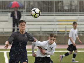 Josh Nagorski (left) of Assumption College and Ben Marcella of St. John's College chase the ball during a high school boys soccer match on Wednesday at the Bisons Alumni North Park Sports Complex. (Brian Thompson/The Expositor)