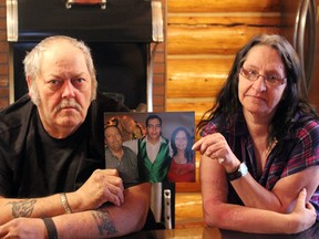 Don and Yvonne McLellan sit in their Parkland County home with a portrait of themselves and their late son, Don Jr.