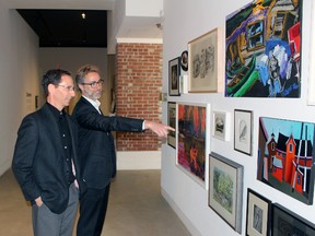 Pete Thomas, left, and Rick Orr check out some of the art they will be auctioning off at Gallery Stratford on Thursday, April 26, 2018 in Stratford, Ont. The pair is co-hosting the live auction at Gala at the Gallery, slated for May 4. Terry Bridge/Stratford Beacon Herald/Postmedia Network