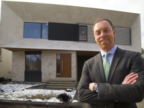 Trevor Delaire, board chair of the Children’s Health Foundation, shows off one of the two modern dream homes up for grabs in the latest version of the popular Dream Lottery. In addition to the two $1.3 million homes, the lottery offers a $1.2 million Bayfield cottage package. (Mike Hensen // Postmedia News)