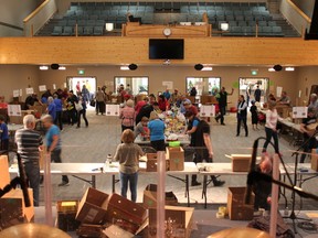 Activettes and Helping Hands volunteers came together at the Cochrane Alliance Church to sort thousands of boxes of food.