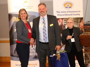 Prince Edward County Chamber of Commerce executive director Emily Cowan (left) and vice-president Sandy Latchford (right) say farewell to Gil Leclerc at the annual general meeting this week. Leclerc isn’t going anywhere, but is stepping down as president of the association.