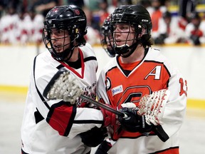 Wallaceburg Red Devils captain Cory Lucier, left, and Point Edward Pacers' Cory Burr battle in front of the Red Devils' net in the second period at Wallaceburg Memorial Arena in Wallaceburg, Ont., on Thursday, April 26, 2018. (MARK MALONE/Chatham Daily News/Postmedia Network)