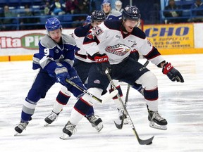 Dawson Baker, left, of the Sudbury Wolves, attempts to strip the puck away from KeatonMiddleton, of the Saginaw Spirit, during OHL action at the Sudbury Community Arena in Sudbury, Ont. on Friday Jan. 19, 2018. John Lappa/Postmedia Network