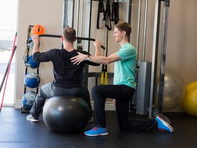 Submitted photo
Joe Stilwell, fitness and health promotion program graduate, helps a client. Students in Loyalist College’s new Occupational Therapist Assistant and Physiotherapist Assistant (OTA/PTA) diploma program will share some courses with fitness and health promotion program students.