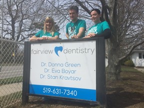 Fairview Dentistry in St. Thomas held its third annual Give Back Smile Back day Friday where the dental practice treated patients at no charge. The program is held for people with no dental insurance or the funds to get dental cleanings or work done. Brenda Gregory, left, Dr. Stan Kravtsov and Lindsay Bogart all volunteered their time along with a number of other employees. (Laura Broadley/Times-Journal)